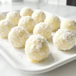 To make these tasty treats, you need: - 1 cup cream cheese, softened - 1/2 cup powdered sugar - 1 teaspoon vanilla extract - 1 cup shredded coconut (plus extra for rolling) - 1 cup crushed graham crackers - 1/4 cup chopped white chocolate or white chocolate chips - Pinch of salt These main ingredients come together to create a creamy and sweet flavor. The cream cheese adds richness, while the powdered sugar gives a nice sweetness. The coconut brings a tropical twist, and the graham crackers add crunch. You can also try these to enhance your coconut cream balls: - Almond extract - Different types of nuts, like chopped almonds or pecans - Dried fruit, such as cherries or cranberries These optional ingredients let you play with flavors. Almond extract gives a nice nutty taste. Nuts and dried fruit add texture and extra taste. Get creative and make it your own! You will need a few simple tools: - Mixing bowl - Electric mixer or whisk - Measuring cups and spoons - Parchment paper - Tray for chilling Having these tools ready makes the process easy. A mixing bowl helps combine all the ingredients well. The electric mixer speeds up the mixing, but a whisk works too. Parchment paper keeps your tray clean. Start by gathering your ingredients. You will need cream cheese, powdered sugar, vanilla extract, shredded coconut, crushed graham crackers, chopped white chocolate, and a pinch of salt. In a mixing bowl, combine the softened cream cheese and powdered sugar. Beat them together until the mixture is smooth and creamy. This step is key for a nice texture. Next, add in the vanilla extract and salt. Mix until everything blends well. Gradually fold in the shredded coconut, crushed graham crackers, and chopped white chocolate. Make sure all the ingredients mix evenly. Once your mixture is ready, chill it in the fridge for about 30 minutes. This helps it firm up. After chilling, it’s time to shape the balls. Use your hands to scoop out a small amount of the mixture, about one inch in diameter. Roll it into a ball. Repeat this step until you use all the mixture. For a tasty finish, roll each ball in extra shredded coconut. This gives them a nice look and extra flavor. After shaping, place the coconut-covered balls on a parchment-lined tray. Chill them for another 15 to 20 minutes. This step makes them firm and easy to serve. For a fun presentation, arrange the coconut cream balls on a nice platter. You can sprinkle some shredded coconut on top or use mini cupcake liners. These little touches make your treat look special. Enjoy your no bake coconut cream balls! To get the best texture for your coconut cream balls, ensure your cream cheese is soft. I let mine sit out for about 30 minutes. Mix the cream cheese and powdered sugar until it’s very smooth. Fold in the coconut and graham crackers gently. This keeps the mix light and fluffy. Don't rush the chilling step. Refrigerate the mixture for at least 30 minutes before shaping. This helps the balls hold their shape. One common mistake is not measuring the ingredients correctly. Use measuring cups for precision. Another mistake is skipping the chilling time. If you skip it, the mixture can be too sticky to handle. Also, avoid using too much white chocolate. A little goes a long way for flavor. Lastly, don’t forget to roll the balls in extra shredded coconut. It adds a nice touch and keeps them from sticking. For a beautiful presentation, use a decorative platter. Arrange the coconut cream balls in a circle or rows. You can sprinkle extra shredded coconut on top for flair. Another fun idea is to place each ball in mini cupcake liners. This adds color and makes them easy to grab. You can also garnish with mint leaves for a pop of green. These small touches make your treat look gourmet. {{image_2}} You can make chocolate-coated coconut cream balls for a rich twist. Start by melting 1 cup of white chocolate or dark chocolate in a bowl. Dip each chilled ball into the melted chocolate using a fork. Make sure to coat each ball evenly. Place them back on the parchment-lined tray. Let the chocolate harden before serving. This adds a sweet crunch and a lovely contrast to the creamy coconut. If you need a nut-free option, simply skip any nuts or nut extracts. The recipe already uses graham crackers, which are nut-free. You can also add more coconut for a richer flavor. This way, the treat remains safe for those with nut allergies. Everyone can enjoy these tasty bites without worry. You can switch things up by adding different flavors. For a hint of almond, mix in 1/2 teaspoon of almond extract. This gives your coconut cream balls a nice, sweet touch. You can also experiment with other extracts like lemon or orange for a fruity twist. Each variation brings a unique taste to your no-bake treat, making it fun to explore! To keep your coconut cream balls fresh, store them in an airtight container. This helps prevent them from drying out or absorbing odors from the fridge. You can layer them with parchment paper to avoid sticking. Keep them in the fridge for best results. These tasty treats can last about one week in the fridge. After that, they may lose flavor and texture. Always check for any signs of spoilage before eating, like an off smell or change in texture. If you want to save some for later, freezing works great. First, place the coconut cream balls on a baking sheet. Freeze them for about an hour until firm. Once frozen, transfer them to a freezer bag or container. They can last up to three months in the freezer. When you’re ready to enjoy them, just thaw them in the fridge overnight. Yes, you can make No Bake Coconut Cream Balls ahead of time. They taste great after chilling. I suggest making them one day prior to serving. This way, the flavors blend nicely. Just store them in the fridge until you're ready to serve. If you need a cream cheese substitute, try using Greek yogurt. It has a similar texture. You can also use mascarpone cheese for a richer taste. Another option is to use a dairy-free cream cheese if you want a vegan choice. To store leftovers, place them in an airtight container. Keep them in the fridge for up to one week. If you want to keep them longer, you can freeze them. Just make sure to separate layers with parchment paper to avoid sticking. No Bake Coconut Cream Balls are simple and fun to make. We covered the main and optional ingredients, tools needed, and the step-by-step process. You can shape them, chill them, and even dress them up for serving. Remember the tips to get the best texture and avoid mistakes. Try variations like chocolate coating or nut-free options for extra fun. Store them properly to keep them fresh. Enjoy these tasty treats with friends and family. Making these coconut balls can bring joy and sweetness to your day.
