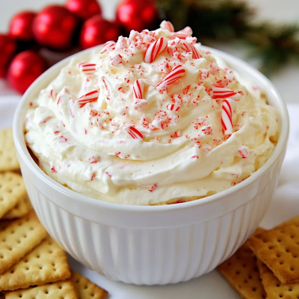 When I make Peppermint Candy Cane Dip, I gather all the needed ingredients first. This makes the process smooth and fun. Here’s what you will need: - 1 cup cream cheese, softened - 1 cup powdered sugar - 1 teaspoon vanilla extract - 1 teaspoon peppermint extract - 1 cup whipped topping (like Cool Whip) - 1/2 cup crushed candy canes (plus extra for garnish) - 1 tablespoon crushed candy canes for garnish - Graham crackers or fresh fruit for dipping Cream cheese is the base of this dip. It gives a rich and creamy texture. The powdered sugar adds sweetness and helps balance the flavors. For flavor, I use vanilla and peppermint extracts. These make the dip taste like the holidays. Whipped topping makes it light and fluffy. Crushed candy canes add a crunchy texture and a burst of minty flavor. I always save some for garnish. Graham crackers or fruit are perfect for dipping into this tasty treat. You can enjoy this dip at any holiday party or cozy night in. {{ingredient_image_1}} - Mixing Cream Cheese and Sugar Start by softening the cream cheese. Place it in a medium bowl. Add the powdered sugar. Use a hand mixer and beat until the mix is smooth and creamy. This will be the base of your dip. - Adding Flavor Extracts Next, add the vanilla and peppermint extracts. These flavors will bring a festive touch. Mix until everything is fully combined. This step is key for a delicious taste. - Incorporating Whipped Topping Now, fold in the whipped topping gently. This makes the dip light and fluffy. Use a spatula for this step. Be careful not to over-mix, as you want to keep the airiness. - Folding in Candy Canes Carefully stir in the crushed candy canes. They add a nice crunch and peppermint flavor. Make sure they are evenly mixed in. This will give your dip that holiday sparkle. - Chilling the Dip Transfer the dip to a serving bowl. Sprinkle some extra crushed candy canes on top for a festive look. Chill it in the fridge for 30 minutes to 1 hour. This helps the flavors blend well. Serve with graham crackers or fresh fruit for dipping. Enjoy your tasty holiday treat! Beating Techniques: Start with room-temperature cream cheese. This helps you mix easier and faster. Use a hand mixer to beat the cream cheese and powdered sugar. Mix until it’s smooth and creamy. This step is key to a fluffy dip. Combining Ingredients: Add the vanilla and peppermint extracts next. Mix them in well. Then, gently fold in the whipped topping. This keeps the dip light and airy. Finally, stir in the crushed candy canes. Make sure they are evenly spread throughout the dip. Chilling: After mixing, cover the dip and chill it for 30 minutes to 1 hour. Chilling helps the flavors blend together. It also firms up the dip, making it perfect for serving. Additional Candy Cane Crumbles: For a festive touch, sprinkle extra crushed candy canes on top before serving. This adds color and crunch. It makes your dip look extra special. Alternative Toppings: You can also use mini chocolate chips or crushed nuts. These give a fun twist to the dip. You can even drizzle chocolate sauce on top for a sweet finish. Pro Tips Use Room Temperature Cream Cheese: This helps create a smooth and creamy dip without lumps, ensuring a delightful texture. Adjust Peppermint Flavor: If you prefer a milder peppermint taste, start with half the peppermint extract and gradually add more to your liking. Chill for Better Flavor: Allowing the dip to chill for at least 30 minutes helps the flavors meld together, enhancing the overall taste. Experiment with Dippers: While graham crackers are classic, try using pretzels, apple slices, or even cookies for a fun twist! {{image_2}} You can change the flavor of your dip in fun ways. Try using different extracts. Almond extract adds a nutty taste. Chocolate extract gives a rich touch to the dip. You can also switch sweeteners. Use honey or agave syrup for a sweeter option. Each change makes the dip unique and delicious. Let’s talk about how to serve your dip. While graham crackers are tasty, you can try other dippers. Fresh fruit, like strawberries or apple slices, works well too. You could even use pretzels for a salty kick. Want to be extra festive? Create a peppermint charcuterie board! Add bowls of the dip, various dippers, and some holiday treats. Mix in cheese, nuts, and more candy canes. This will wow your guests and make your dessert table shine! Refrigeration Tips Store your leftover peppermint candy cane dip in an airtight container. This will keep the dip fresh and tasty. Place the container in the fridge. It will last for up to four days. Always check for any changes in smell or texture before eating. Freezing Instructions You can freeze this dip, but it may change in texture. To freeze, place the dip in a freezer-safe container. Seal it tightly and label it with the date. It can last for up to two months. When you're ready to eat it, thaw it in the fridge overnight before serving. Avoiding Texture Changes If you want to reheat the dip, do so gently. Use a microwave on low heat and stir often. This helps keep the dip creamy. Avoid high heat, as it may cause the dip to separate. For best taste, serve it cold or at room temperature. Can I make this dip ahead of time? Yes, you can make this dip a day before your event. Just store it in the fridge. This helps the flavors blend well. Remember to give it a good stir before serving. What can I use instead of cream cheese? You can use Greek yogurt or mascarpone cheese. Both will give a creamy texture. They also add a twist to the flavor. Is this recipe suitable for parties? Absolutely! This dip is perfect for holiday gatherings. It’s sweet, festive, and fun to eat. Serve it with graham crackers or fruit for a tasty treat. How long will the dip last in the fridge? The dip will stay fresh for about 3 to 5 days in the fridge. Keep it in an airtight container to maintain its flavor. Just remember to enjoy it before it’s gone! This blog post covered how to make a delicious peppermint candy cane dip. We discussed key ingredients like cream cheese, flavor extracts, and crushed candy canes. You learned the step-by-step method for mixing and chilling the dip. We also shared tips for perfecting texture and fun serving options. In the end, this dip is perfect for any gathering. It’s easy to make, and you can customize flavors. Enjoy making your own version and sharing it with friends and family.